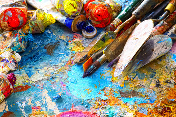 Fototapeta premium Paints and brushes,lying on painted background