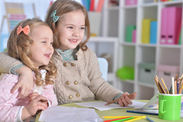 Two cute little  girls drawing