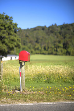 Red Mail Box in Front of a House