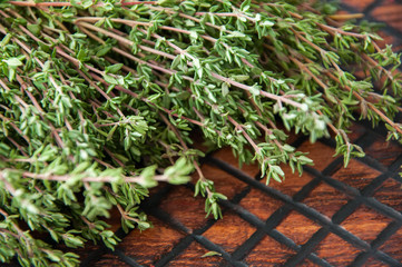 Fresh thyme on a wooden board. Selective focus. Close up.
