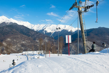 Beautiful view from the peak of snowy hill with chairlift for tourists with ski and snowboards