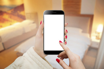 Women holding black phone in hands and making a room reservation 