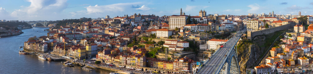 Fototapeta na wymiar Wide angle Panorama of old town Porto, Portugal. Douro river and the Dom Luis Bridge.