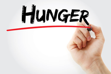Hand writing hunger with marker, concept background