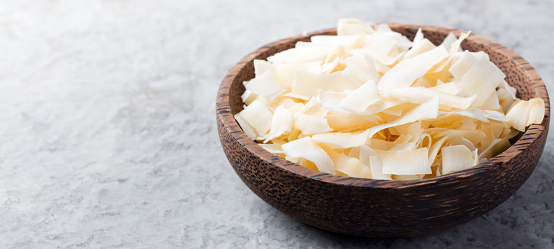 Coconut chips flakes with sugar, salt. Copy space.
