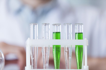 the vial with the green substance