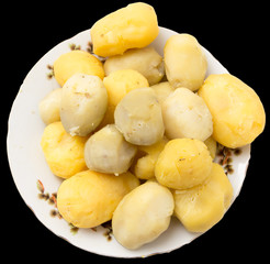 boiled potatoes on a black background