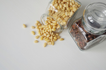 Pine nuts are peeled and unpeeled together scattered from the jars