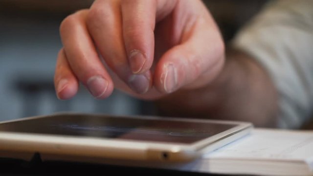 Male Fingers Touch Sensory Screen Of Computer Tablet For Working, Looking Through Files And Zoom Them