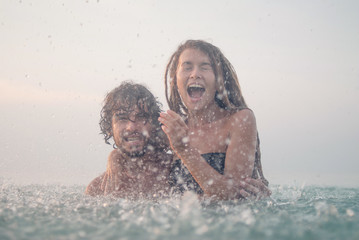 young couple having fun in the sea