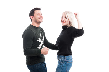 Smiling couple with raised hands