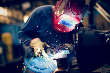 Fototapeta Welding steel with sparks using mig mag welder  obraz