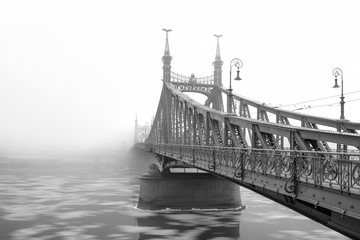 The Liberty Bridge in Budapest in a foggy morning, Hungary.