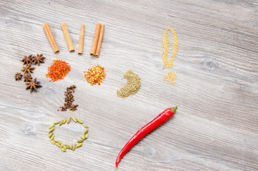 Spices arranged in a playful smileys on a wooden background