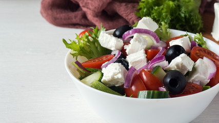 Fresh Greek salad in a white bowl