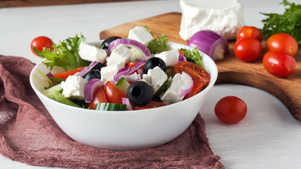 Greek salad with fresh vegetables, feta cheese and black olives