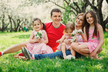 Fototapeta premium big family with three little daughters spending time together in summer park, mother, father and sisters having fun outdoor