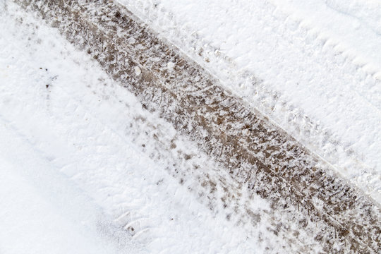 traces of cars on the road in winter