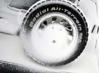 spare wheel on the rear of the car covered with snow