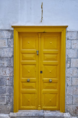 vintage house yellow door in a Greek island village