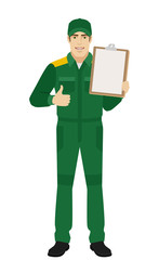 Man in uniform holding clipboard and shows thumb up