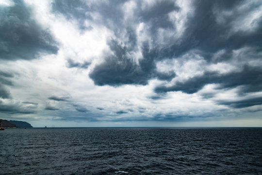 Atlantic Ocean with dramatic blue sky and clouds behind cruiser