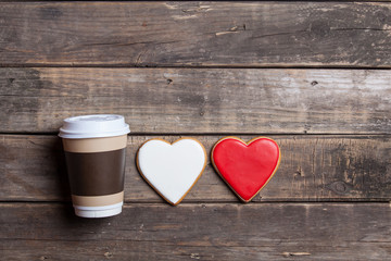 heart shaped cookies and cup of coffee on the wonderful brown wooden background