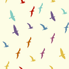 Fototapeta premium Colorful silhouettes of flying birds seamless pattern