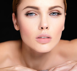Obraz premium beautiful woman model with no makeup and clean healthy skin face on black background.