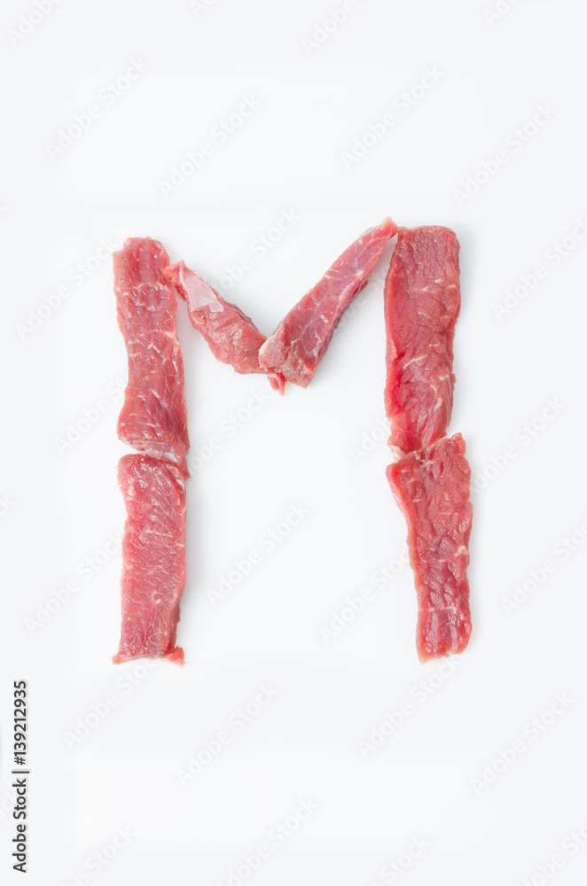 Wall mural the letter m latin alphabet of red beef meat on a white background