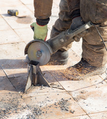 Worker cuts metal in the park