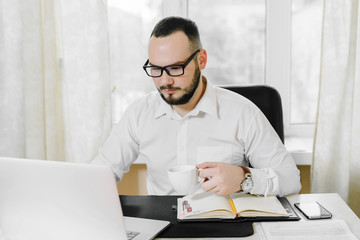 businessman drinking coffee in the workplace