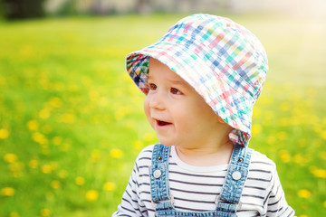Little boy in hat standing on the field