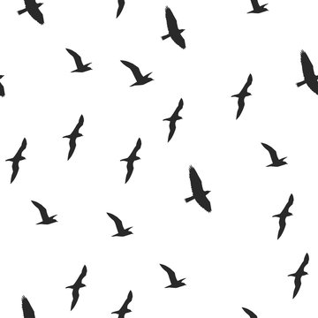 Colorful silhouettes of flying birds seamless pattern
