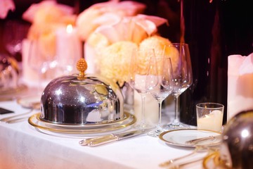 Beautiful table setting with crockery and flowers for a party, wedding reception or other festive event