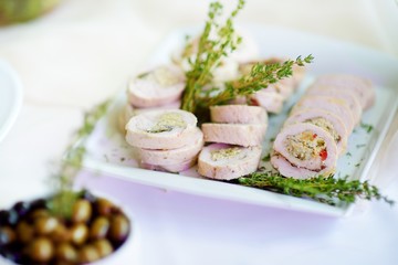 Delicious chicken or turkey rolls with herbs served on a party or wedding reception