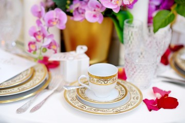 Beautiful table setting with crockery and flowers for a party, wedding reception or other festive event