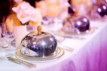 Beautiful table setting with crockery and flowers for a party, wedding reception or other festive event