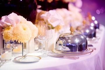 Beautiful table setting with crockery and flowers for a party, wedding reception or other festive event