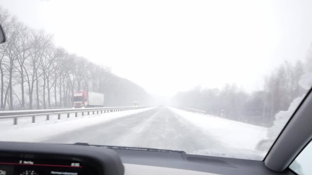 Driver's POV of driving on a highway on a winter day