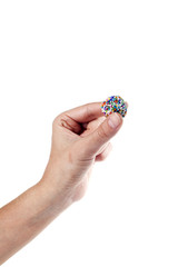 Hand holding a traditional candy from Brazil called brigadeiro over white background