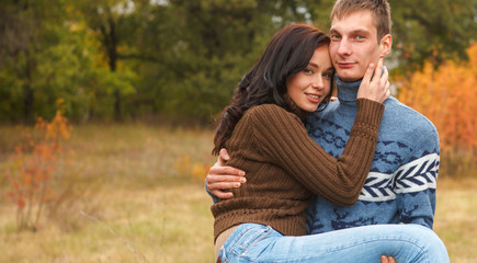 Fototapeta premium girl at the hands of Man. A loving couple walking in the autumn park.