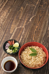 noodles with sauce or shoyu and ingredient on wood backgroound.
