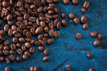 roasted coffee beans on blue table, can be used as a background