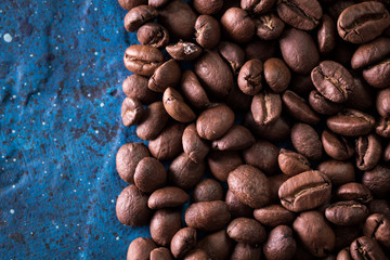 roasted coffee beans on blue table, can be used as a background