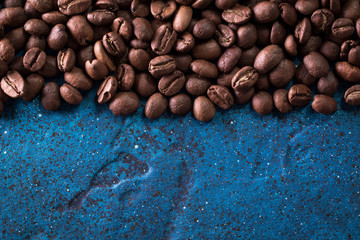 roasted coffee beans on blue table, can be used as a background