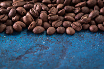 roasted coffee beans on blue table, can be used as a background