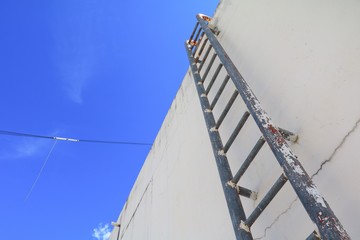Fototapeta premium Staircase old vertical industrial metal rusted. to Water tank no safety rails