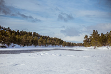 A beautiful landscape with a frozen river in the Norwegian winter