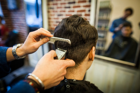 Hair stylist using comb and razor